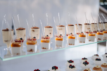 Set of delicious sweet cakes and dessert in the restaurant. Scene is celebratory and festive