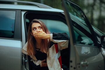 Car Passenger Suffering from Severe Motion Sickness. Sad girl feeling queasy and nauseated from...