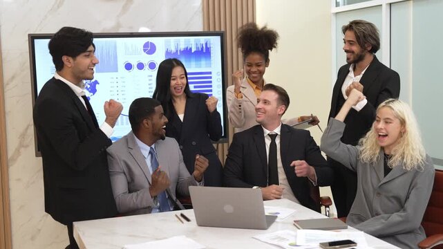 Diverse group of office worker and employee feels happy and excited and celebrate for being good teamwork and positive attitude contribute to business success in ornamented workplace