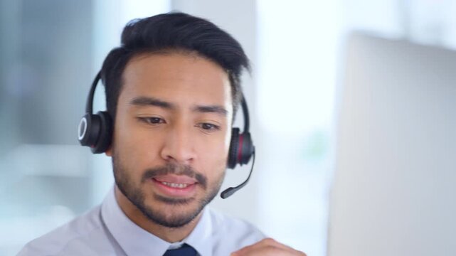 Confident and reassuring salesman consulting and operating a helpdesk for customer service and support. Call center agent talking and listening to a client on a headset while working in an office.
