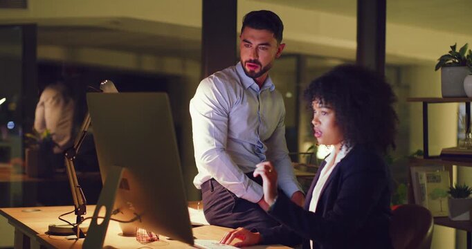 Two thinking lawyers working on computer late at night, meeting or talking while planning strategy for deadline court case. Paralegal attorneys discussing solution while researching evidence together
