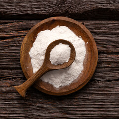 Baking soda powder in spoon and bowl - Healthy food.