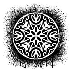 Mandala stencil over black paint splash