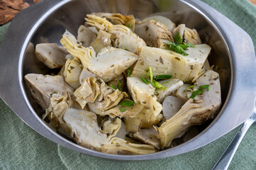 Italian food, pickled grilled artichokes hearts in olive oil close up