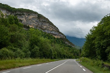 Driving car or camper on free road Route Napoleon in French Alps, touristic road in France