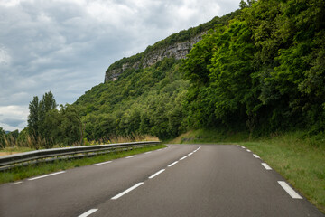 Driving car or camper on free road Route Napoleon in French Alps, touristic road in France