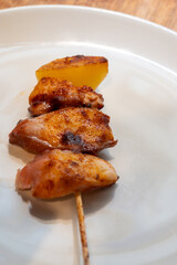 Typical snacks of Basque Country, pinchos or pinxtos skewers with small pieces of bread, fish, sea food, sweet green pepper served in bar in San-Sebastian or Bilbao, Spain