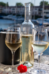 Glasses of cold white Cote de Provence wine in yacht harbour of Port Grimaud, summer vacation on French Riviera in Provence, France, wine tasting