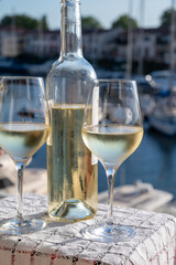 Glasses of cold white Cote de Provence wine in yacht harbour of Port Grimaud, summer vacation on French Riviera in Provence, France, wine tasting