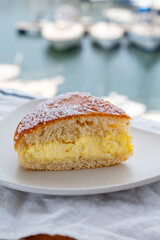 Cake of French Riviera, Tarte Tropezienne cake in yacht harbour of Port Grimaud, summer vacation in Provence, France