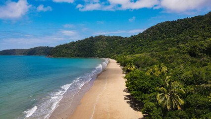 Remote beach in Australia on a sunny day. Daintree and Cape Tribulation location with rainforest and reef taken by drone