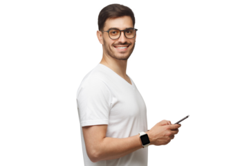 Side shot of young man in white t-shirt, wearing smartwatch on wrist, holding phone and looking at camera with smile