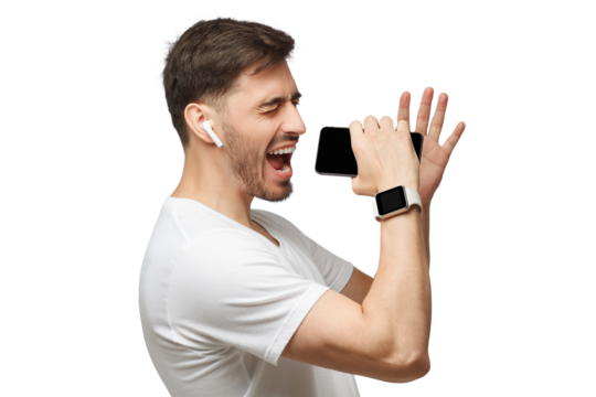 Young handsome man singing his favorite song, using his phone instead microphone, wearing white t-shirt and wireless earphones