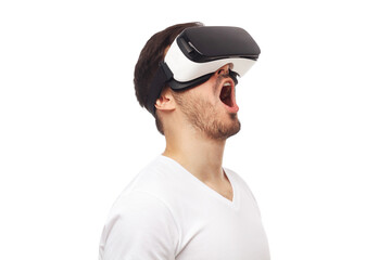 Studio portrait of screaming young man in VR virtual reality glasses