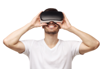 Young smiling man wearing t-shirt and virtual reality headset or VR glasses, playing video game