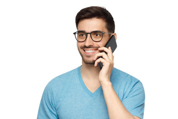 Young smiling man in blue t-shirt holding phone in hand and looking away