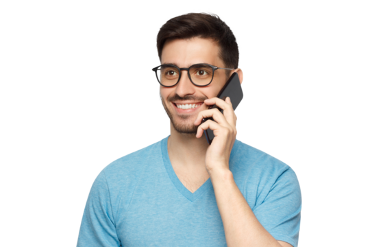 Young smiling man in blue t-shirt holding phone in hand and looking away