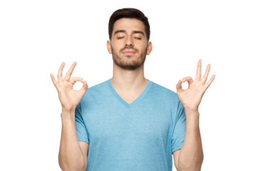 Concentrated relaxed man standing with closed eyes, having relaxation while meditating, trying to find balance and harmony. Yoga and meditation concept