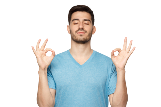 Concentrated relaxed man standing with closed eyes, having relaxation while meditating, trying to find balance and harmony. Yoga and meditation concept