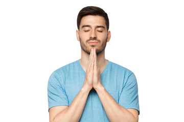 Close-up of young man putting hands together as if he is praying with closed eyes