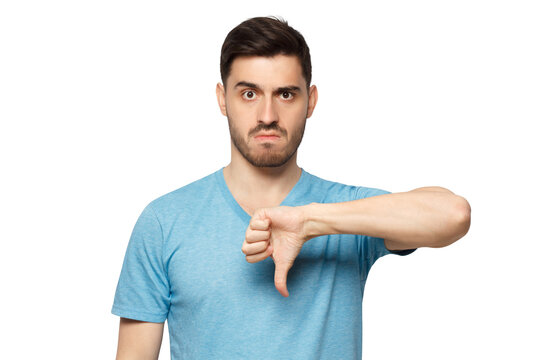 Young dissatisfied man showing thumb down or dislike
