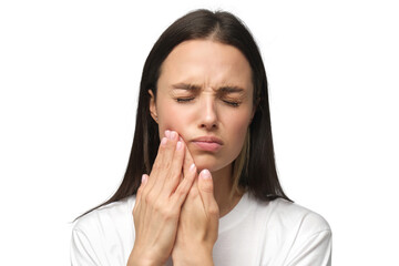 Young woman experiencing severe toothache, pressing hands to cheek, closing eyes because of strong...