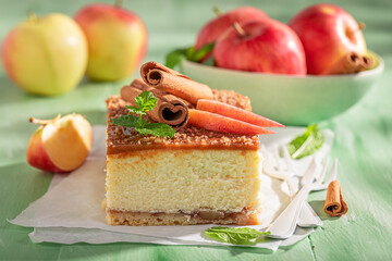Homemade and tasty cheesecake decorated with apples and cinnamon.