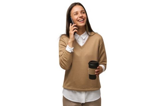 Happy woman smiling and holding coffee cup while talking on the phone