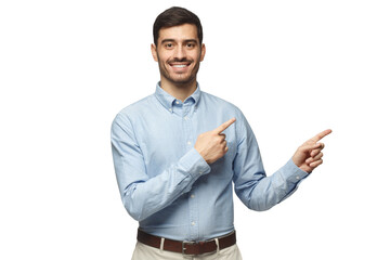 Smiling businessman pointing right with two hands and looking at camera