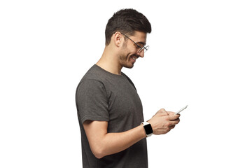 Side portrait of handsome man looking at screen of phone while exchanging messages or surfing web