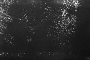 Texture of paper with black ink as background, top view