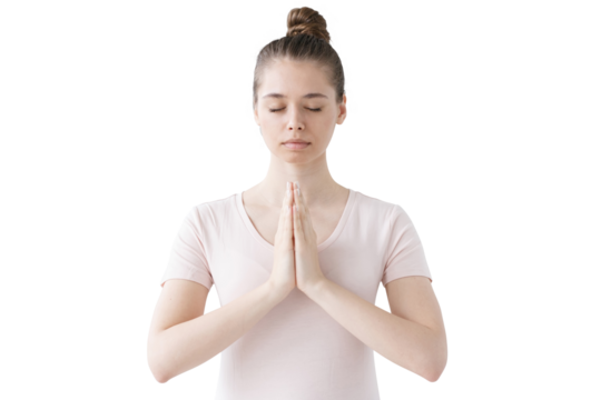 Peaceful woman with eyes closed in prayer position, expressing serenity and meditation