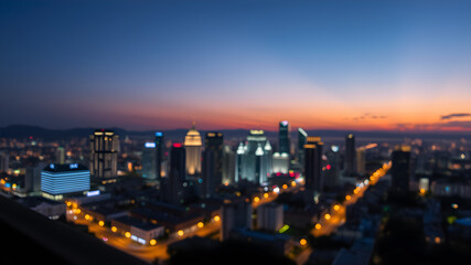 Fototapeta premium Bright glowing lights of district in megapolis under dusk sky in evening on blurred background. Generative AI