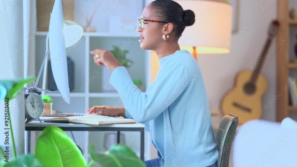 Aufkleber Focused remote student typing and doing research for an academic essay or article while writing notes at a computer desk inside. Female university learner studying for a test or college assignment