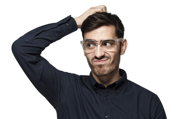 Young thoughtful businessman thinking, scratching his head trying to find solution