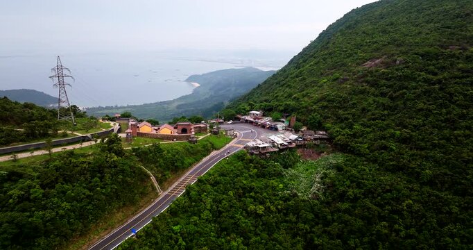 Hai Van Pass, Central Vietnam, Asia - Riders Traversing the Picturesque and Challenging Motorbike Route - Drone Flying Forward