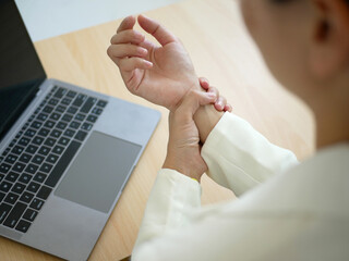 Businesswoman has severe wrist pain Wrist inflammation from sitting and working on a labtop Health...