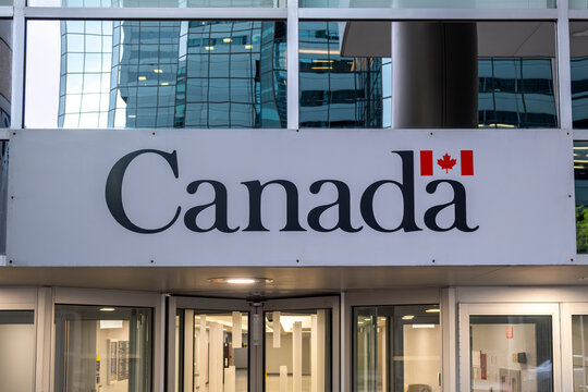 Official sign Canada with Canadian flag on a government building facade in the downtown of a capital city. 