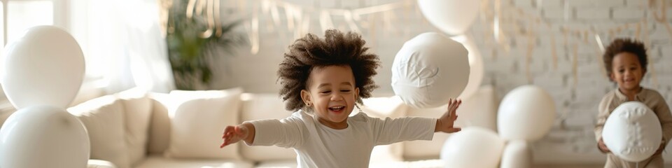 Obraz premium Biracial Family Pillow Fight Celebration in Decorated Living Room – Two Young Children and Parents Enjoying a Playful Morning