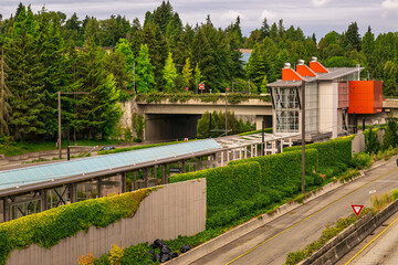 2024-08-13 VIEW OF THE SOUND TRANSIT LIGHT RAIL STATION WITH LUSH GREEN FOLIAGE IN THE BACKGROUND...