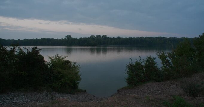 Static shot of a lake near the small town Thalfingen, Elchingen in Germany. Very calm and quiet. No movement in the water.