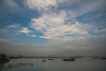 Logistic shipping quay boat Engineering crane depot at logistic export terminal control. Warehouse freight background container yard loading quayside harbor port. Logistics seascape shipping portal