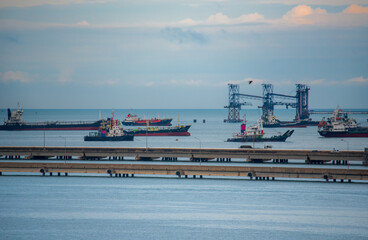 Logistic shipping quay boat in twilight sky night Engineering crane depot at logistic export...