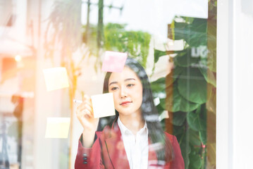 businesswoman taking notes on glass board . Concept of business finances and accounting.