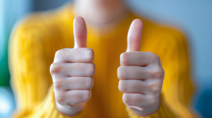 Young Woman Showing Thumbs Up in Yellow Sweater