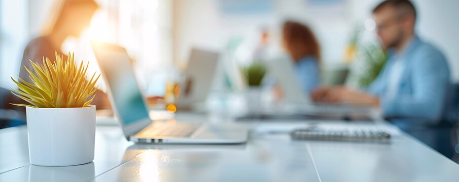 A high-resolution photo of a business team working on laptops in a clean, modern workspace, collaborative and professional, - Powered by Adobe