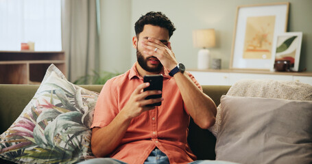 Bad news, phone and stress with man on sofa in living room of home, reading text message...