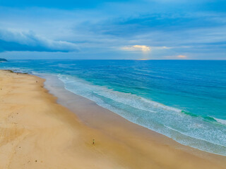Sunrise Seascape with beautiful cloud covered sky and gentle surf