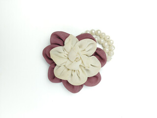 Burgundy and white brooch and handmade beads resemble bright flowers isolated on white background