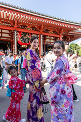 Asian mom and daughters wearing traditional Japanese clothing in Japan. 